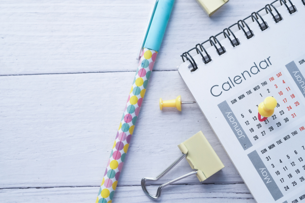 Colorful pen and paper calendar; schedule an appointment