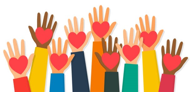 Charity, volunteering and donating concept. Raised up human hands with red hearts. Children's hands are holding heart symbols.
