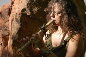 Elaina Geltner, Founder, SoulPath Alchemy, playing a wooden flute