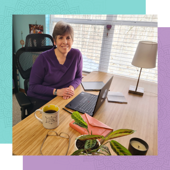 Michele Elias seated at her desk in front of laptop